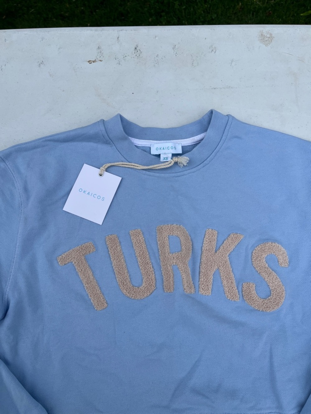 Light Blue Crewneck Sweater with Beige 'TURKS' Chenille Lettering - Picture 2 of 4